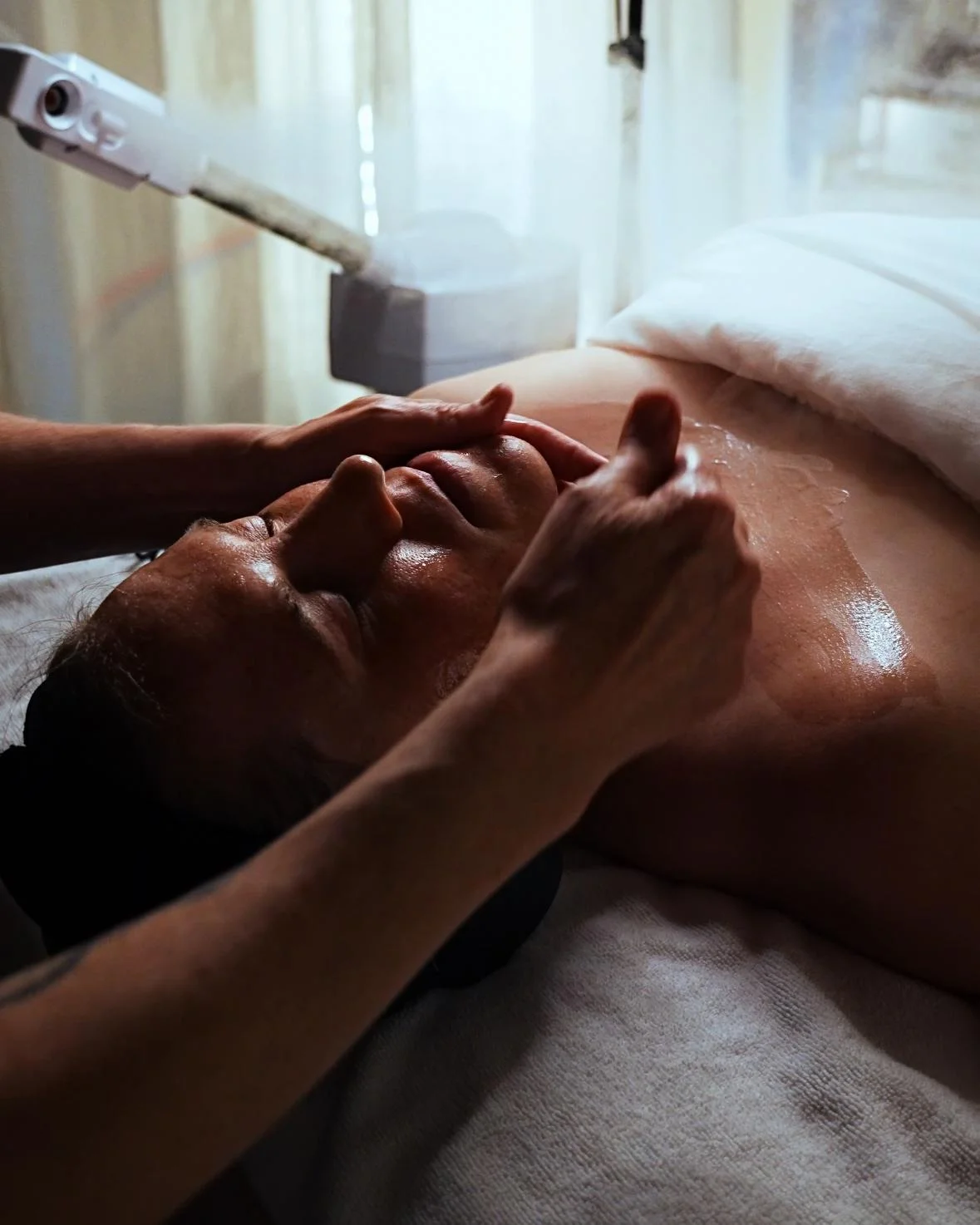 Hands performing a facial massage